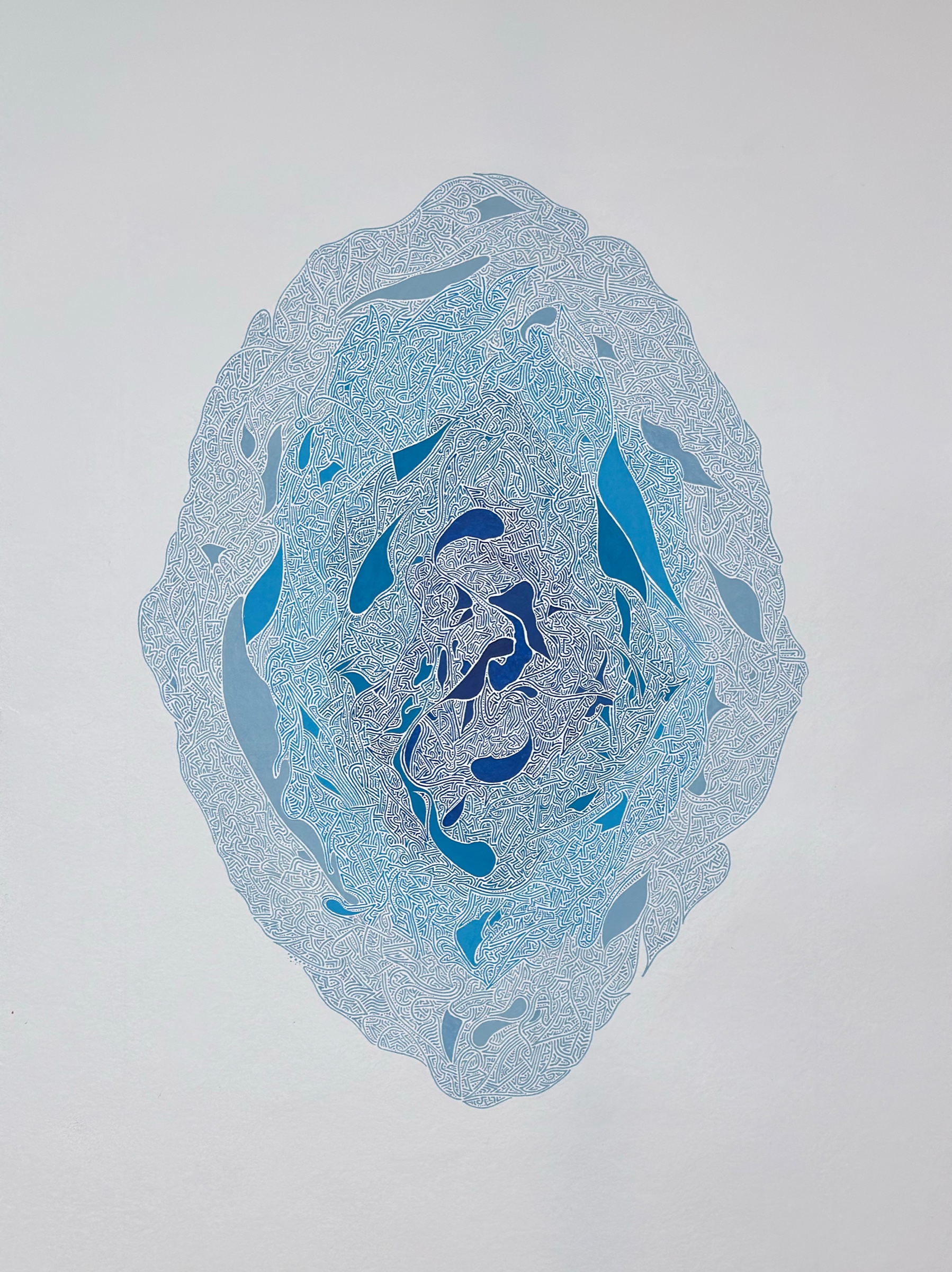 Intricate lines in five shades of blue radiating around a dark centre on pale card